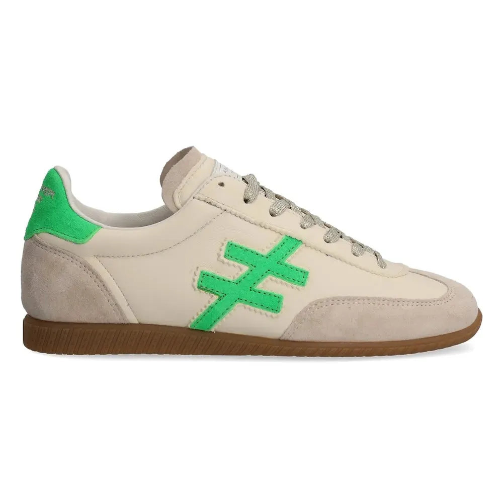 Ladies beige leather lace-up trainers with green accent details and brown rubber sole.