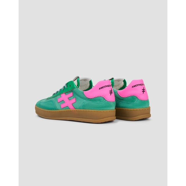 Green and pink suede lace-up trainers with brown soles, featuring 
