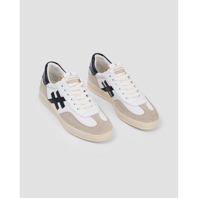 Buffalo Ladies Spanish White Leather Lace-Up Trainers with black logo accents and beige detailing.