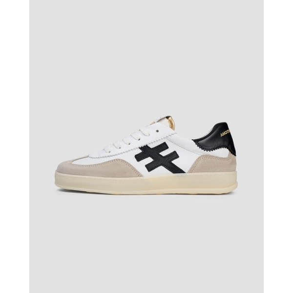 Buffalo Ladies white leather lace-up trainers with black logo, beige accents, and a retro sneaker design.