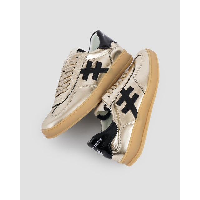 Metallic gold and black leather lace-up trainers with chunky beige soles, stylish trendy design, for women.
