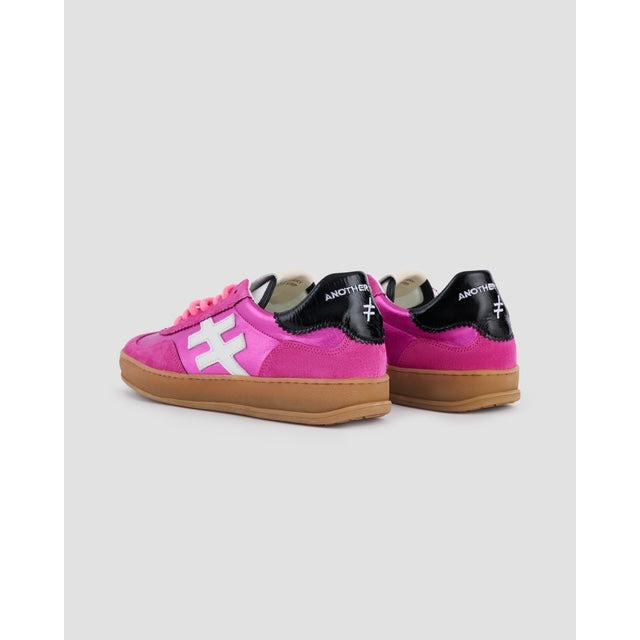Pink suede lace-up trainers for women with white and black accents, gum soles, and trendy casual design.
