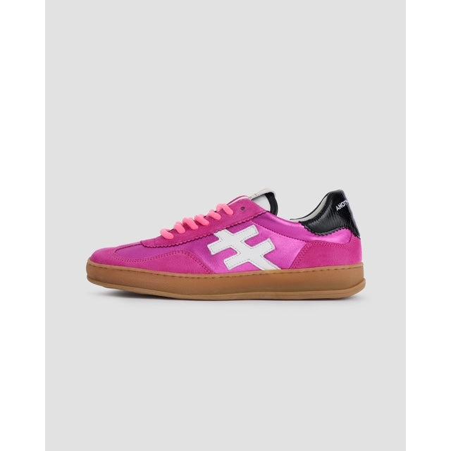 Pink suede lace-up trainers for women, featuring a white cross logo and gum sole, stylish and trendy.