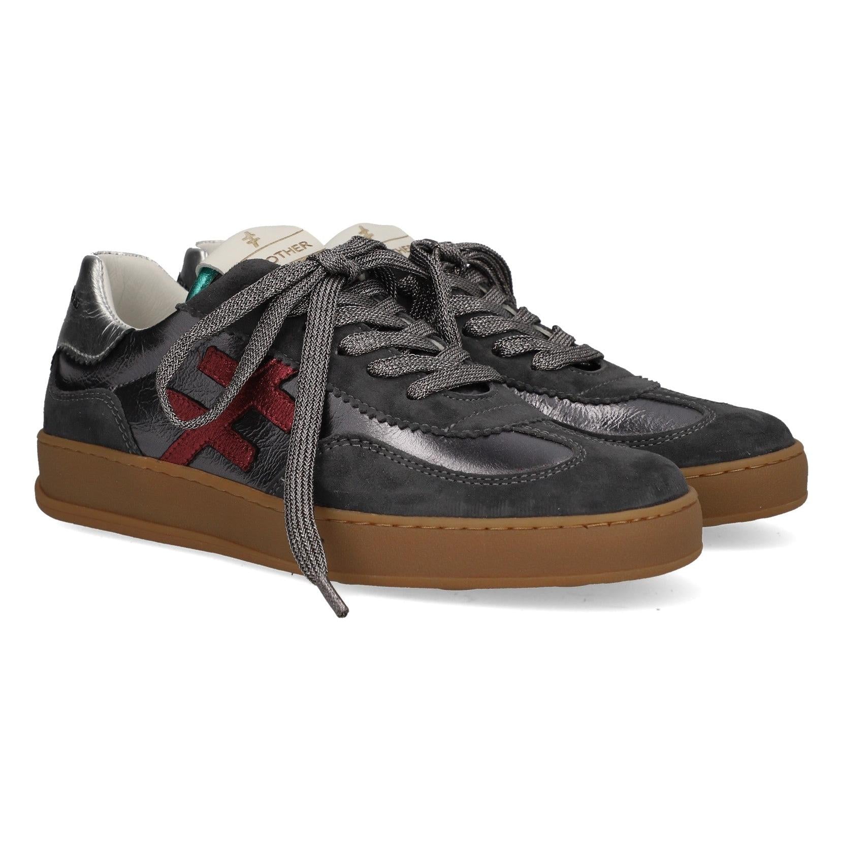 Women's black suede and metallic leather lace-up trainers with red logo detail and brown rubber sole.