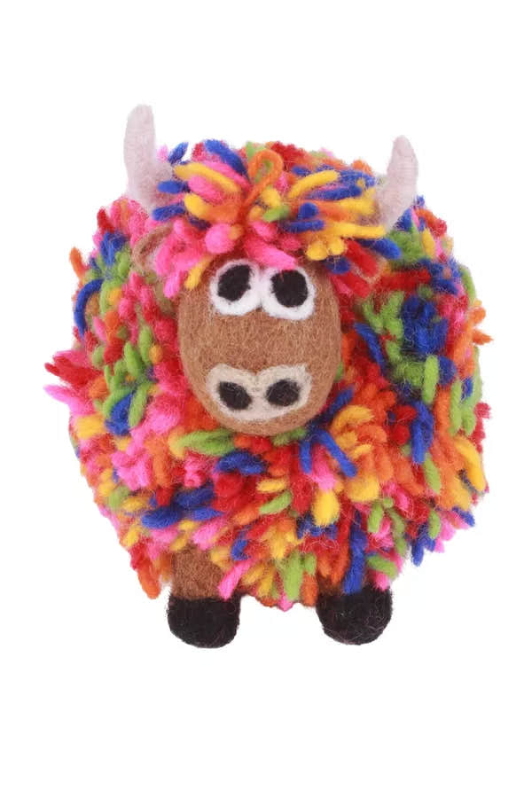 Pachamama Archie Highland Cow plush toy with colorful, curly yarn fur, white horns, large eyes, and black hooves.
