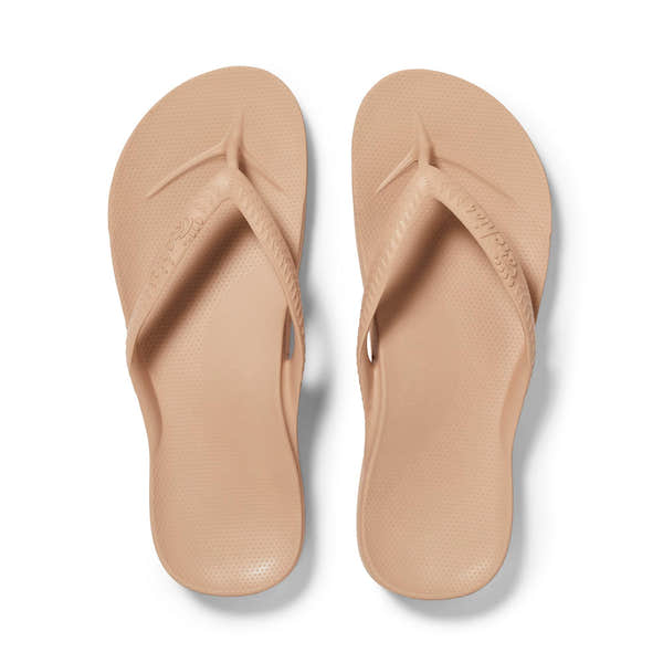 Unisex tan waterproof slip-on sandals with arch support, flip-flop design, and textured footbed for comfort.