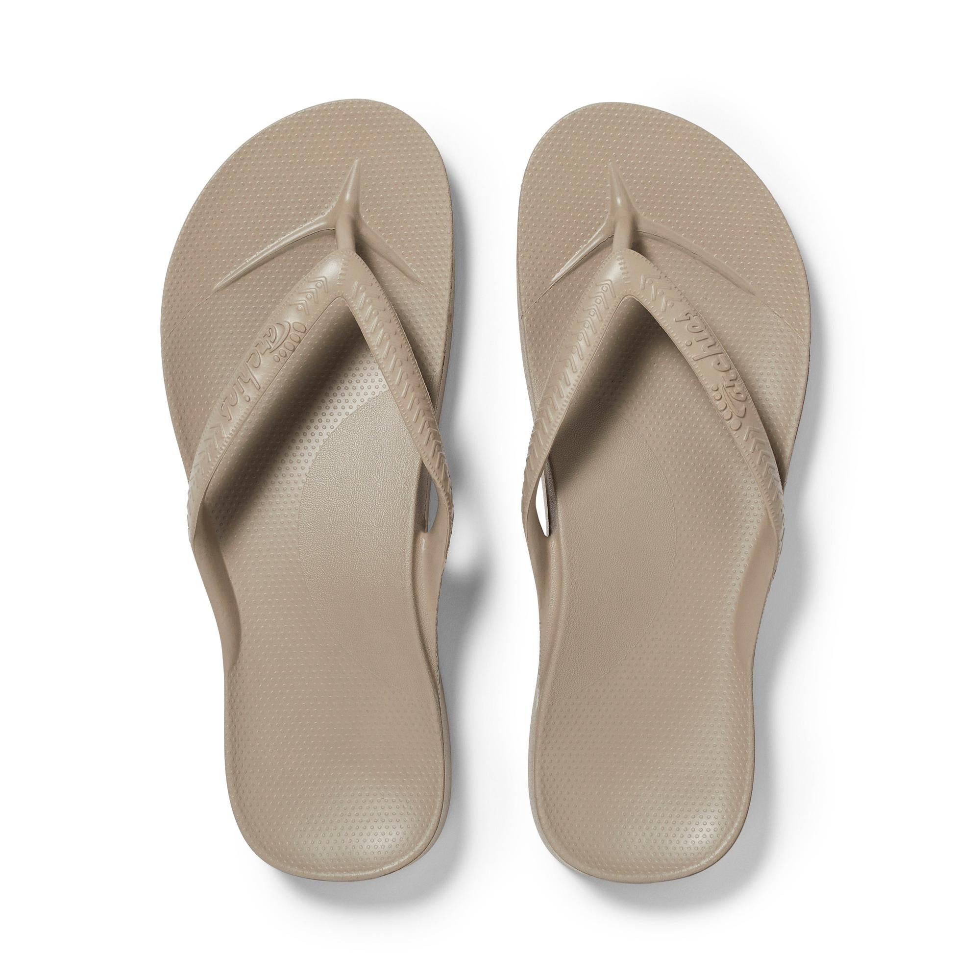 Unisex taupe waterproof slip-on sandals with arch support, moccasin-style straps, and textured footbed for comfort.