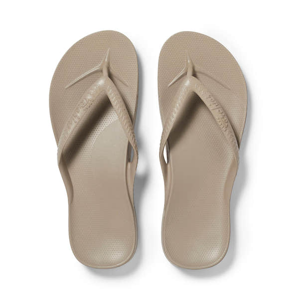 Unisex taupe waterproof slip-on sandals with arch support, moccasin-style straps, and textured footbed for comfort.