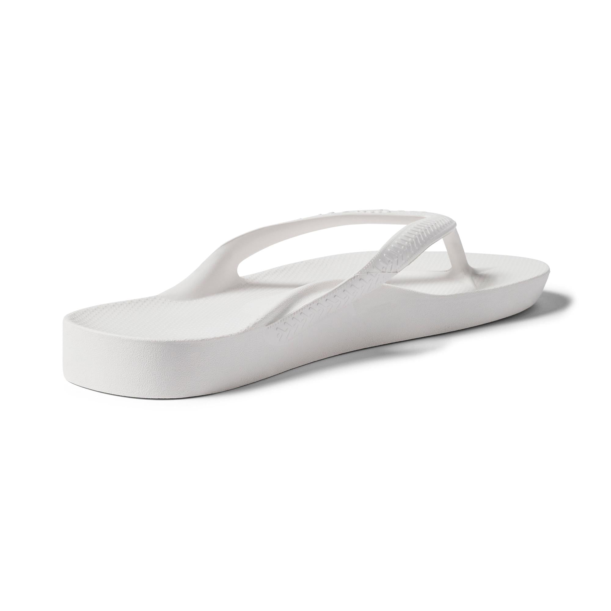 White waterproof unisex Archies Fit Flops slip-on sandals with arch support and textured sole.