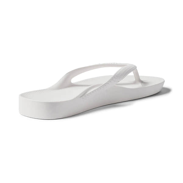 White waterproof unisex Archies Fit Flops slip-on sandals with arch support and textured sole.