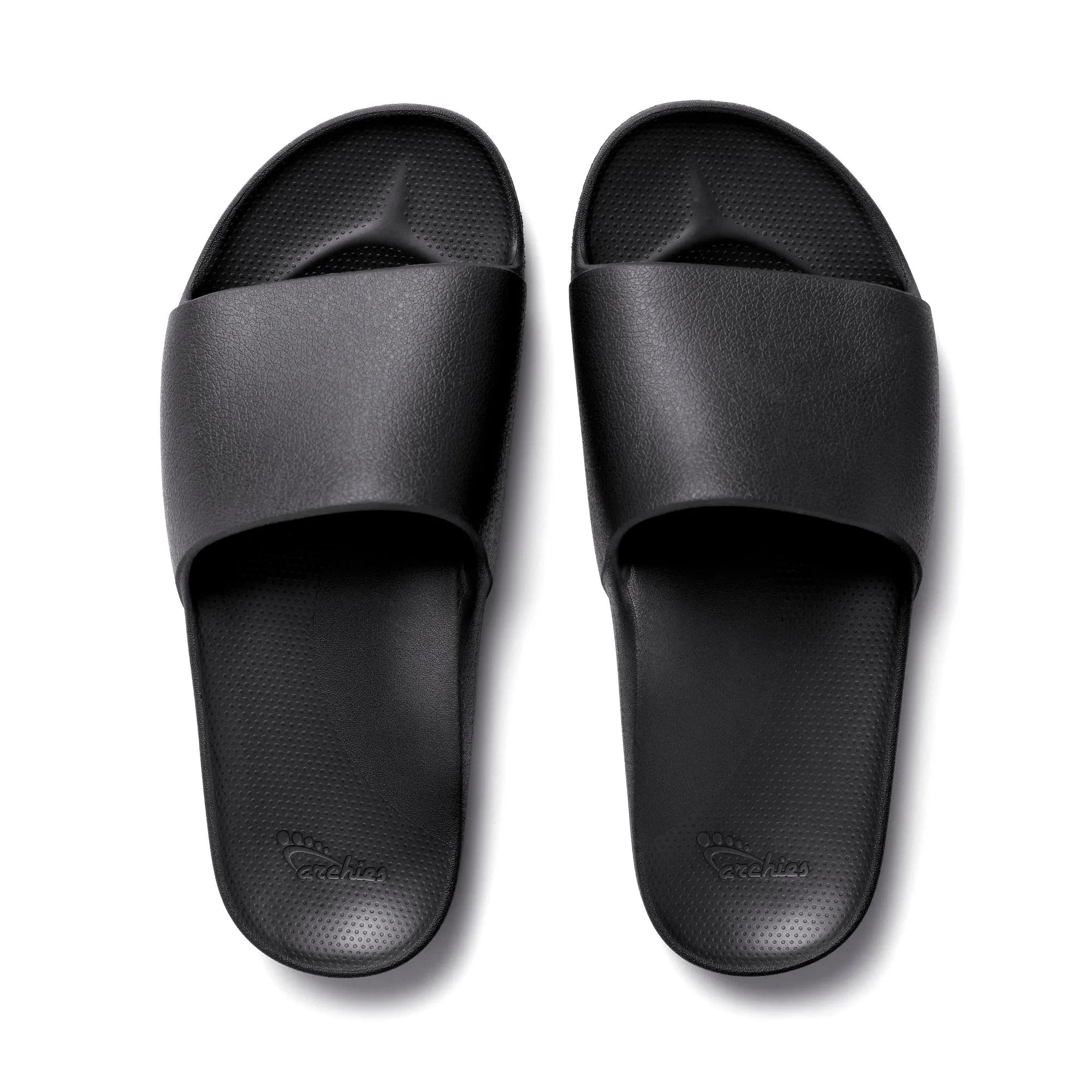 Black waterproof unisex arch support slides with textured footbed and wide strap, ideal for comfort and casual wear.