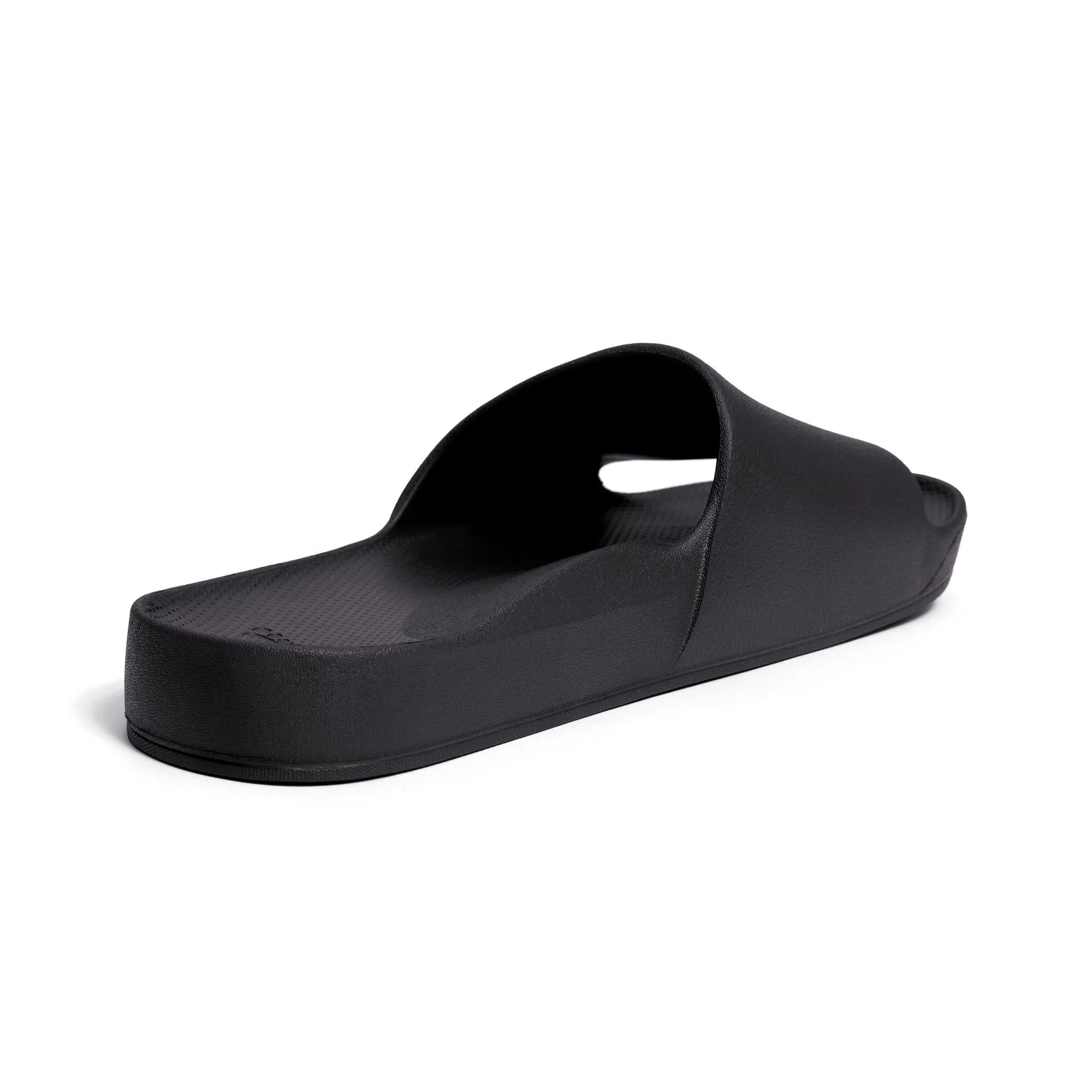 Black waterproof unisex Archies arch support slide sandals with a slip-on design and textured footbed.