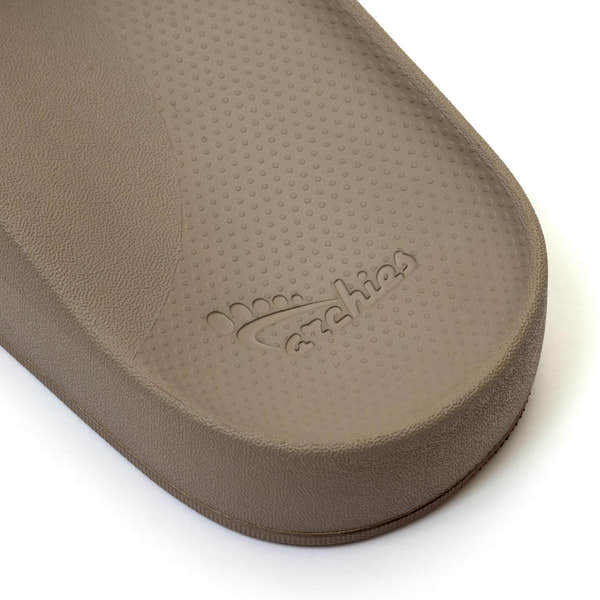 Unisex Taupe waterproof Archies arch support slide sandal with textured footbed and embossed logo.