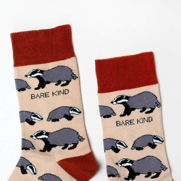 Barekind Save The Badgers bamboo socks with badger pattern, beige background, red top and toe, eco-friendly sustainable hosiery.