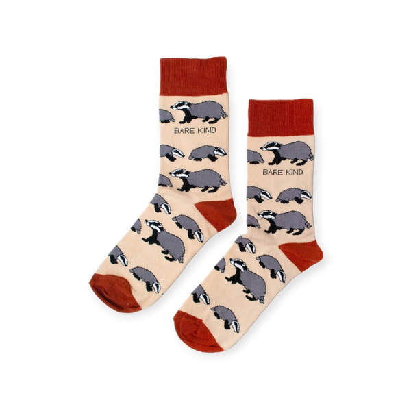 Barekind Save The Badgers bamboo socks with badger animal designs and "BARE KIND" text, in beige with rust and black accents.