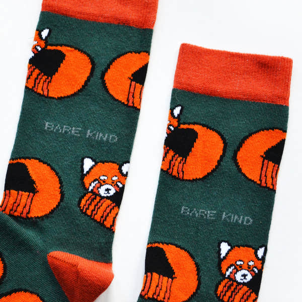 Green and orange Bamboo Socks featuring red panda and bamboo plant designs, with "BARE KIND" branding.