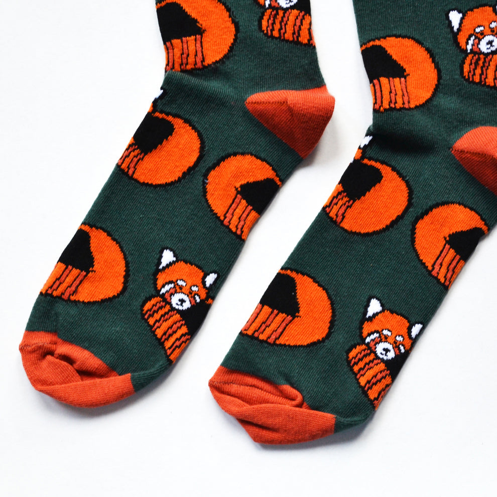 Barekind Save The Reds Pandas bamboo socks with orange and black panda and tiger pattern on dark green background.