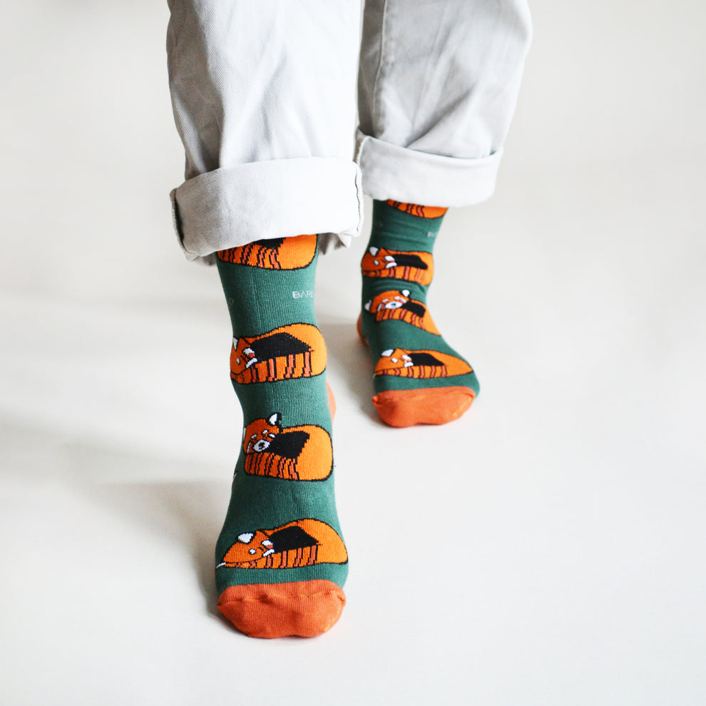 Barekind Save The Reds Pandas bamboo socks featuring adorable orange and black panda design on green background.