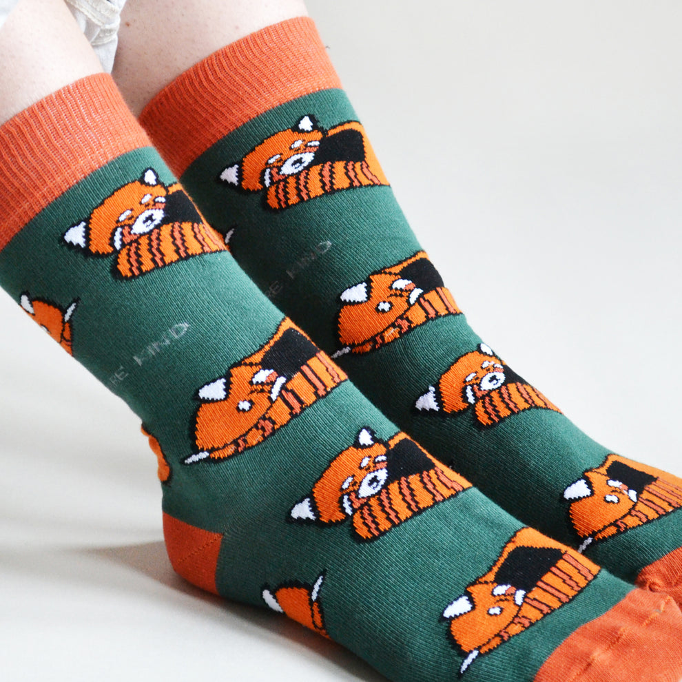 Barekind Save The Reds Pandas Bamboo Socks featuring cute orange panda faces on green and orange background.
