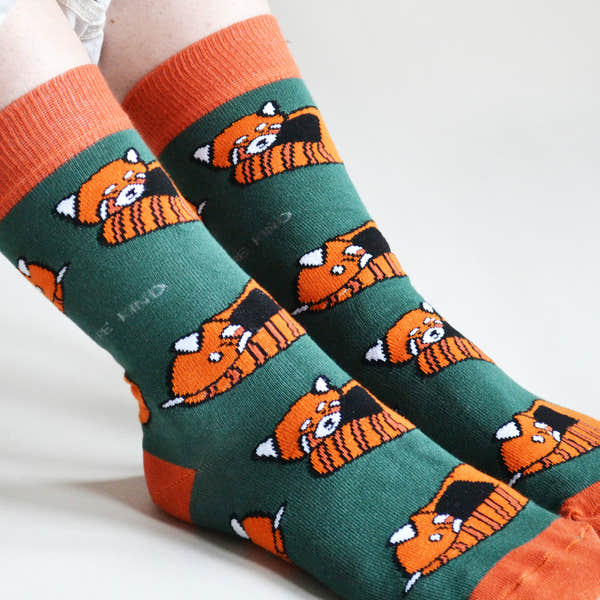 Barekind Save The Reds Pandas Bamboo Socks featuring cute orange panda faces on green and orange background.