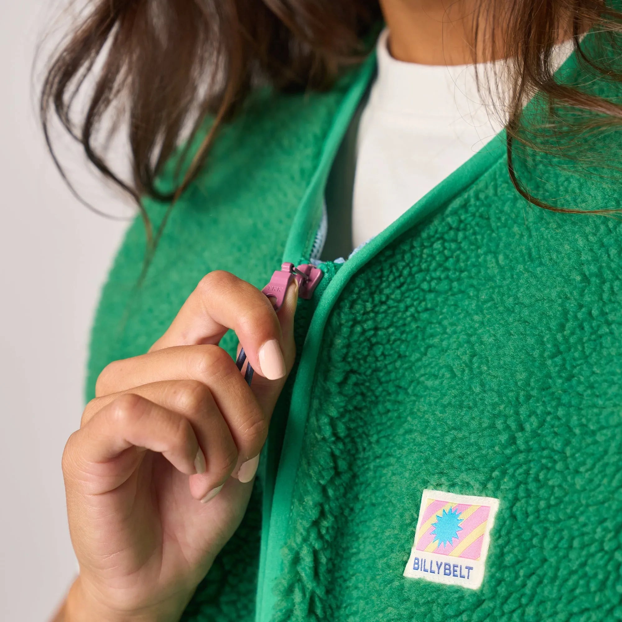 Billy Belt ladies sleeveless sherpa zip jacket in green, featuring a front zipper and logo patch, cheerful and cozy outdoor wear.
