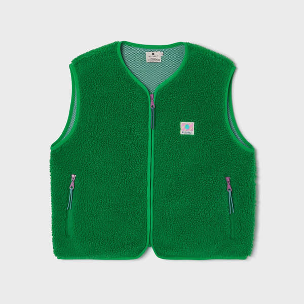 Green sleeveless Sherpa zip-up vest for women with front zip pockets and logo patch, casual stylish layered outerwear.