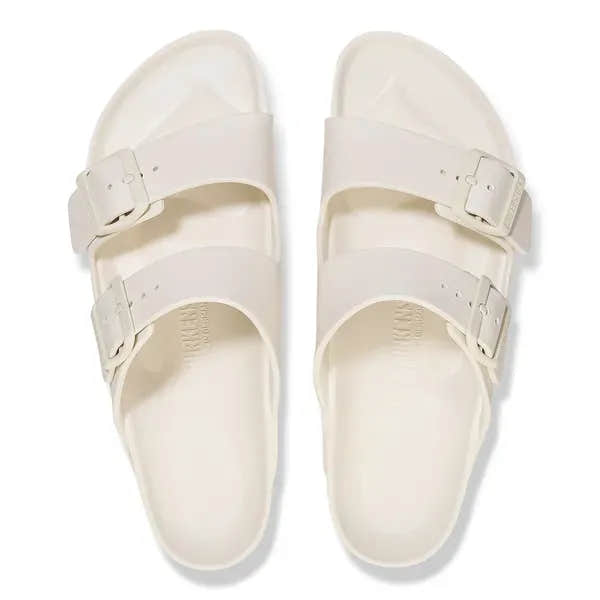 Unisex white Birkenstock Arizona Essentials EVA waterproof slide sandals with arch support and buckles.
