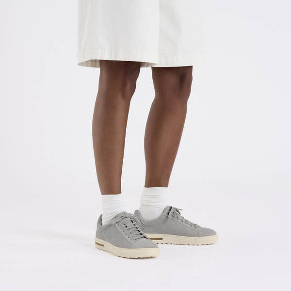 Birkenstock Bend Low Ladies Stone Coin suede lace-up trainers with arch support, casual sporty style, white socks, and neutral color.
