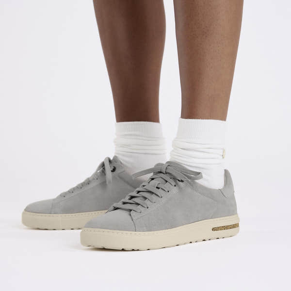 Birkenstock Bend Low Ladies Stone Coin Suede Lace-Up Trainers with arch support, white socks, and light gray color, casual comfort footwear.