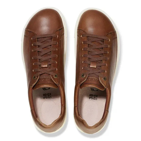 Unisex Cognac Leather Birkenstock Bend Low 1026177 sneakers with arch support, lace-up design, and white rubber soles.