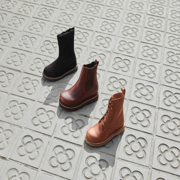 Birkenstock Bryson 1030103 women's cognac leather lace-up ankle boots with arch support, on decorative tiled floor.