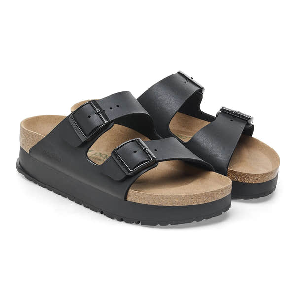Black Birkenstock Papillio Arizona Flex Birkoflor platform sandals with narrow straps, buckles, cork footbed, and arch support.