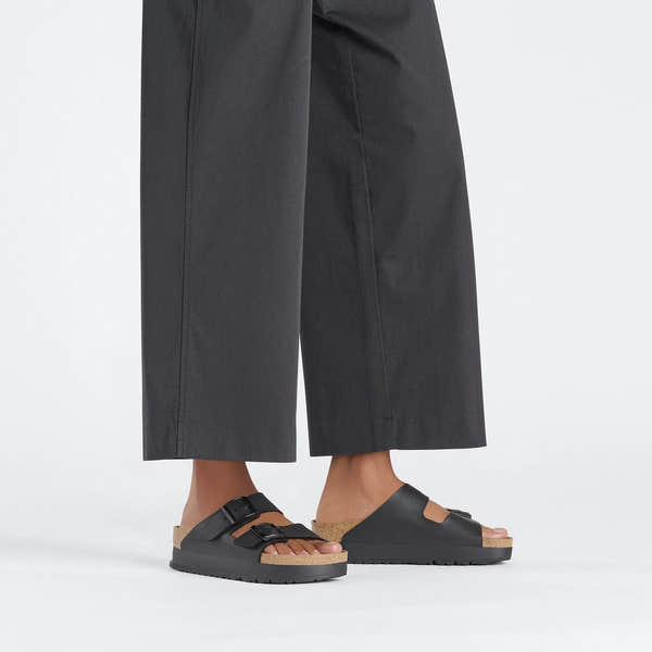 Women's black Birkenstock Papillio Arizona Flex Birkoflor platform sandals with narrow straps, buckle closure, arch support, and cork footbed.