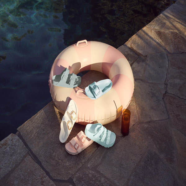 Birkenstock Papillio Florida EVA III Flex platform women's narrow sandals in surf green with buckle and arch support, displayed on poolside stone surface.