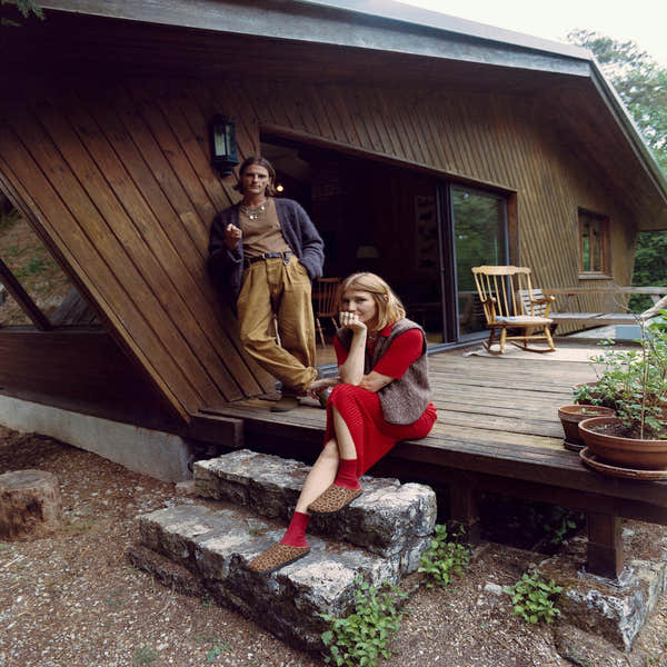 Women wearing Birkenstock Zermatt Leopard Shearling textile slip-on mule shoes on a wooden porch.