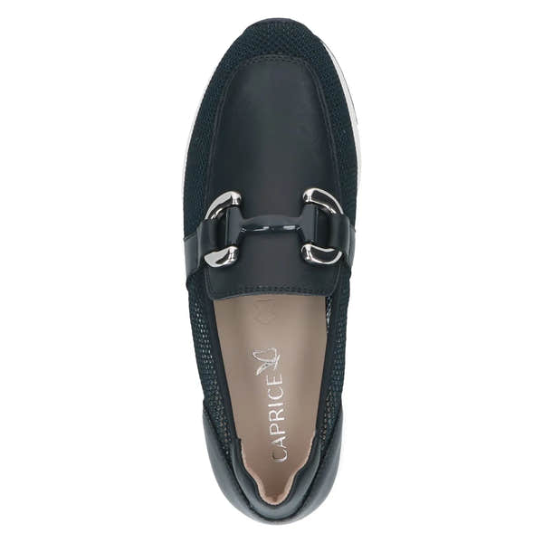 Ladies navy slip-on shoes with leather and textile upper, metal buckle detail, and cushioned beige interior.