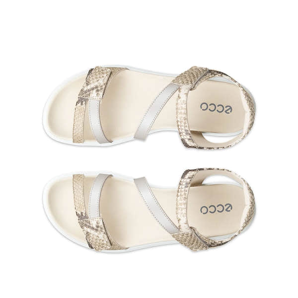 Pair of beige sandals with white straps on a white background
