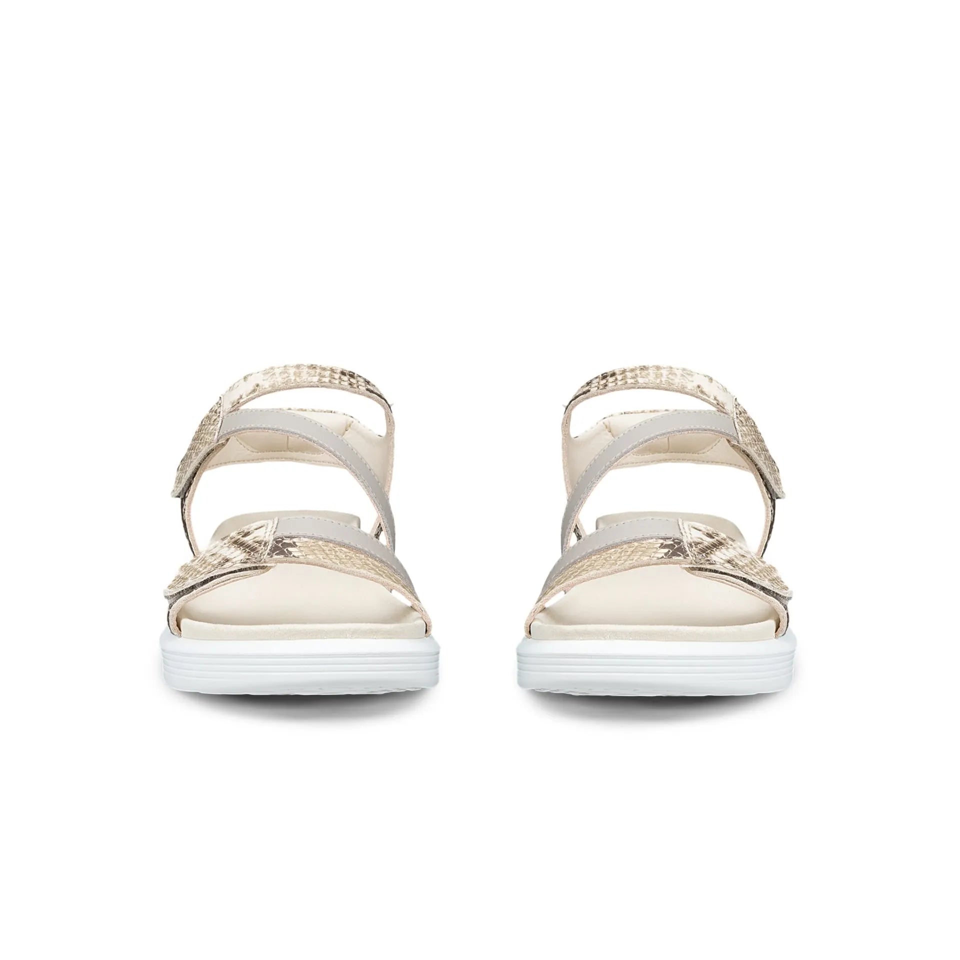 Pair of beige sandals with white soles on a white background