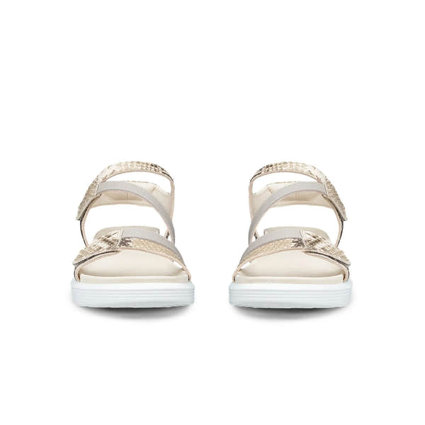 Pair of beige sandals with white soles on a white background