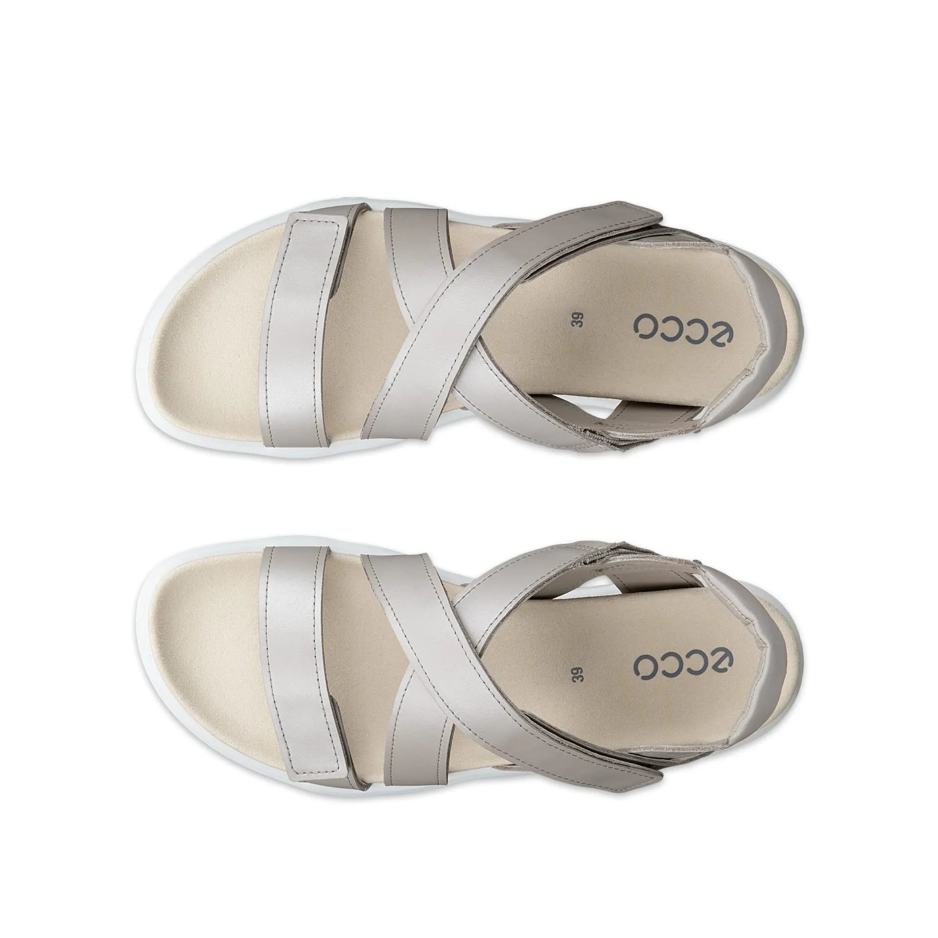 Pair of beige sandals with silver straps on a white background