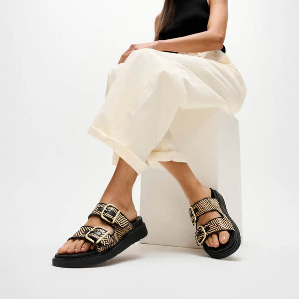FitFlop A2Q-001 Gen-FF Buckle Graphic slip-on sandals for women, black leather and textile with gold buckle accents.
