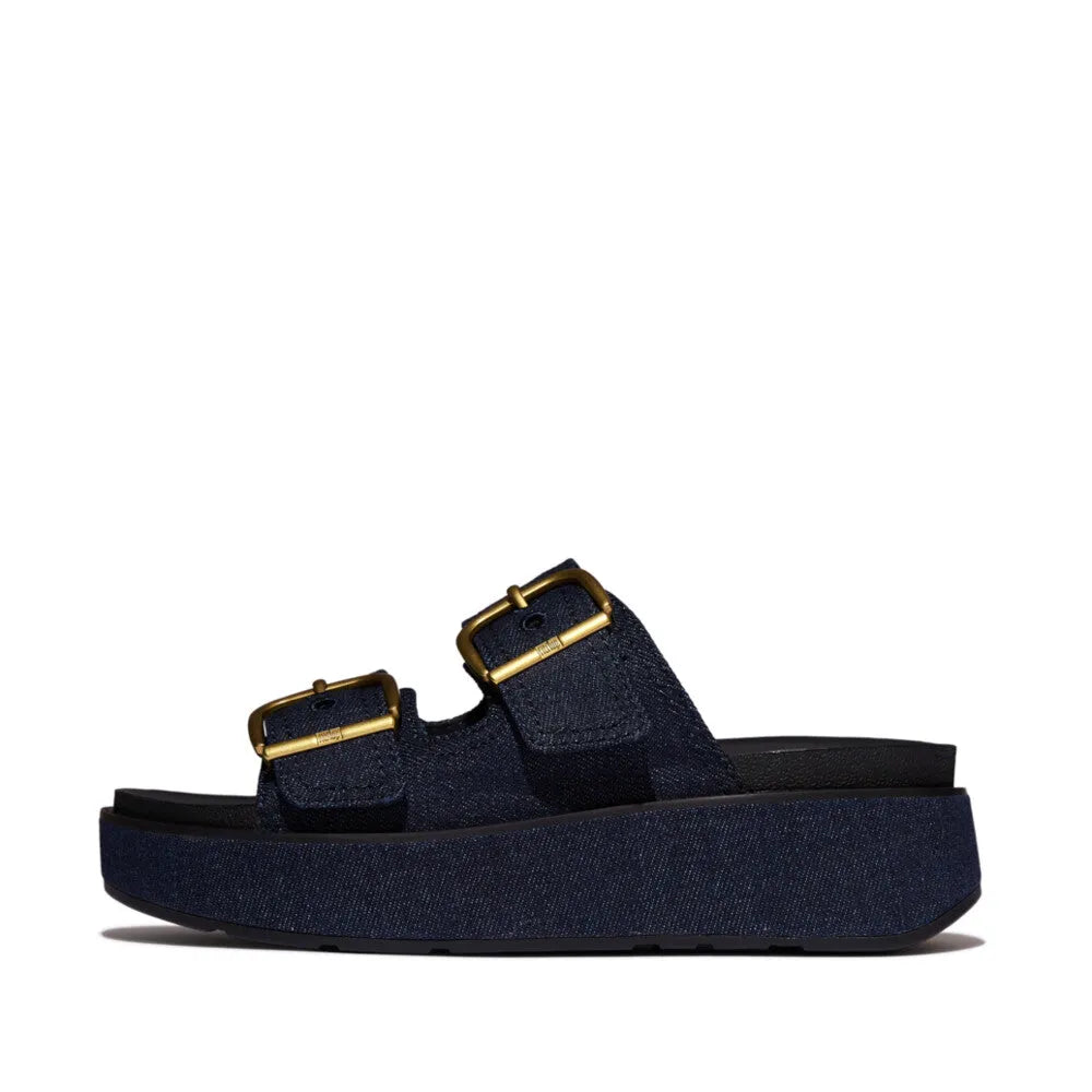 FitFlop ladies' dark denim slip-on sandals with buckle straps, platform sole, and textured textile upper.