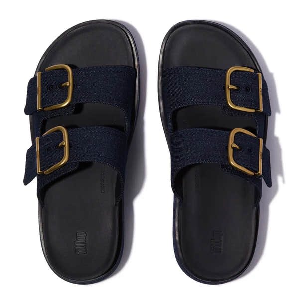 FitFlop ladies' dark denim textile slip-on sandals with gold buckle straps, cushioned footbed, and sturdy sole.