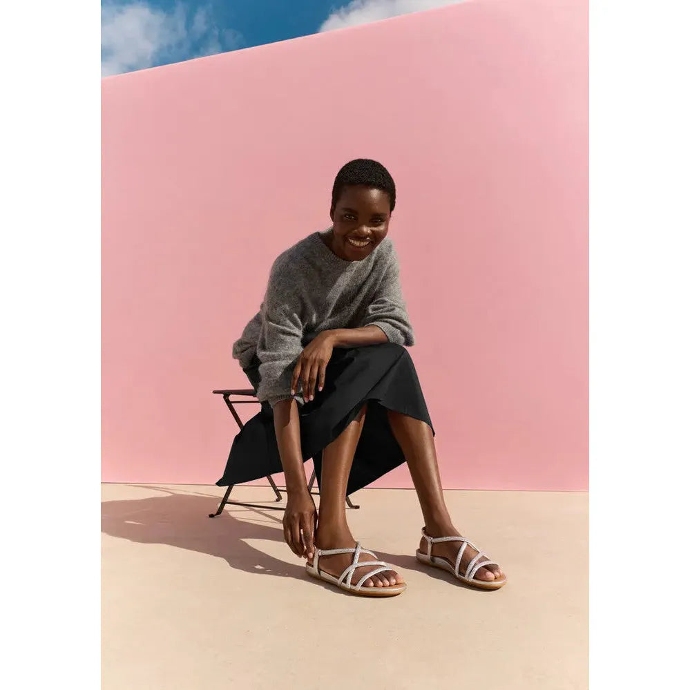 FitFlop Gracie Crystal ladies silver sling back sandals with leather and textile straps, worn by a smiling woman outdoors.