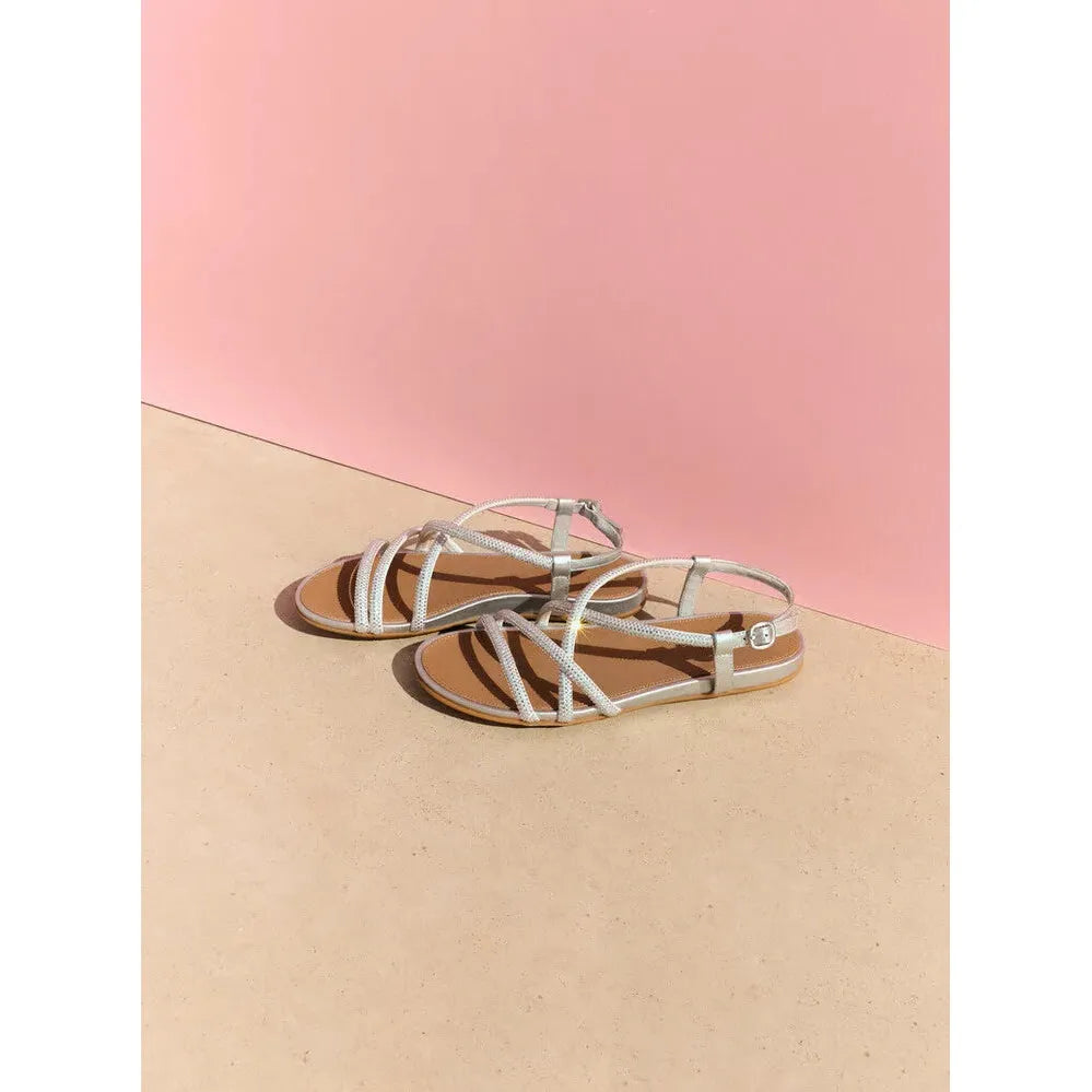 FitFlop Gracie Crystal Ladies Silver Leather & Textile Slingback Sandals on beige and pink background.