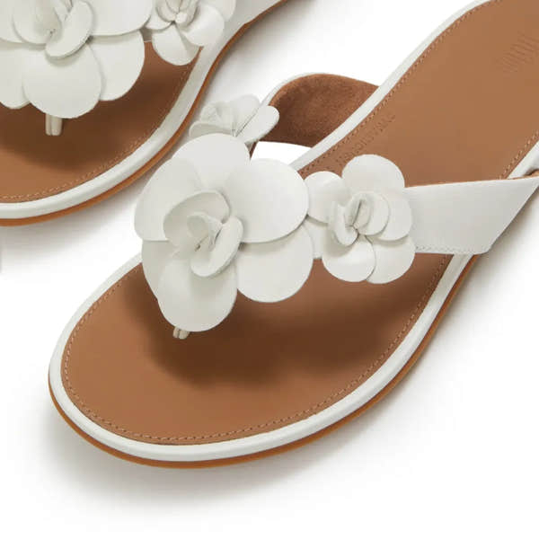 FitFlop A4A-194 Gracie Flower women's white leather T-bar sandals with floral embellishments and tan footbed.