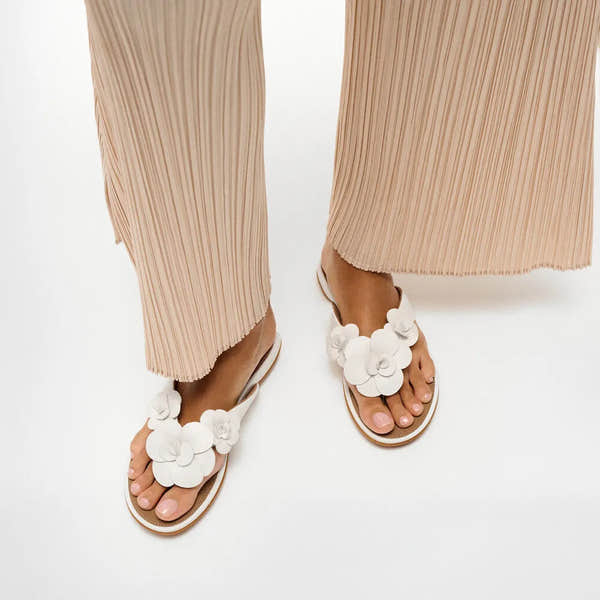 FitFlop A4A-194 Gracie Flower white leather T-strap sandals with floral embellishments for women, stylish and comfortable urban footwear.