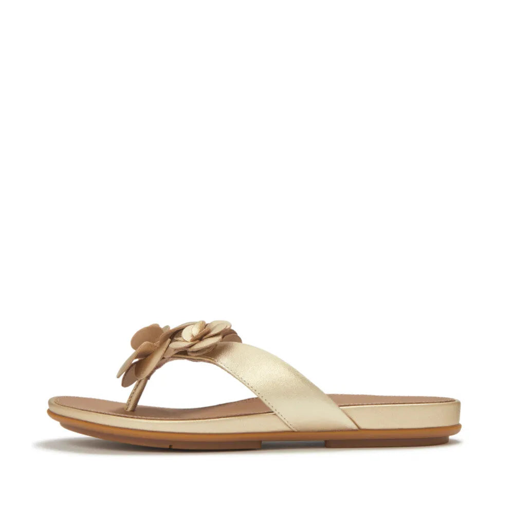 FitFlop A4A-675 Gracie Flower Ladies Platino Leather T-bar Sandals with floral embellishment, flat sole, and open-toe design.