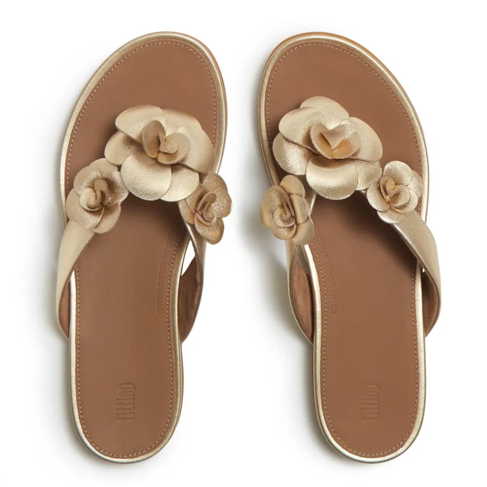 FitFlop A4A-675 Gracie Flower women's platino leather T-strap sandals with floral embellishments.