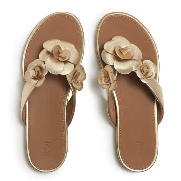 FitFlop A4A-675 Gracie Flower women's platino leather T-strap sandals with floral embellishments.